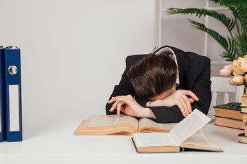 woman sleeps at a desk at work in the office