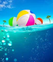 Inflatable balls float in water underwater split image