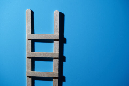 handmade toy step laddle against blue background