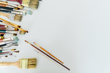 many paint brushes on a white background