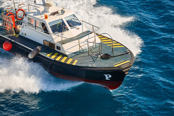 Pilot vessel operating on the sea. Harbor maritime control. Nautical
