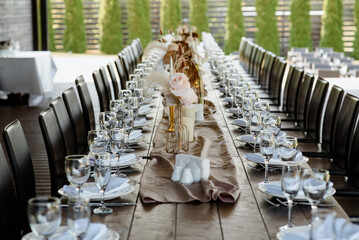 Arranged table with plates and glasses on a wedding reception