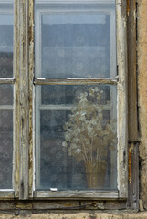 Aged window frame with dry flower decoration