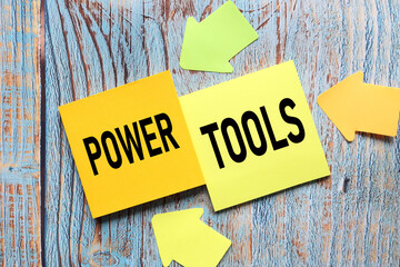 power tools. two stickers with text on a blue wooden background