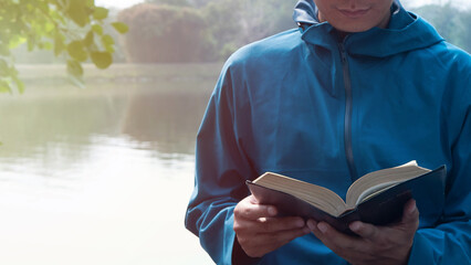 Man holding and reading the scriptures.