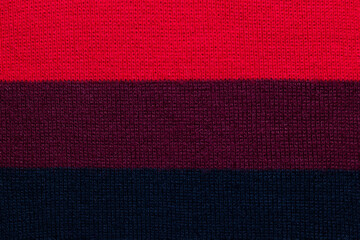 multi colored background. knitted wool fabric texture with stripes