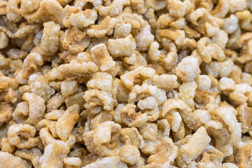 Pork crackling (pork snack, pork scratching) is fried pork skin as snack and we can eat it with noodles in Thai food style.