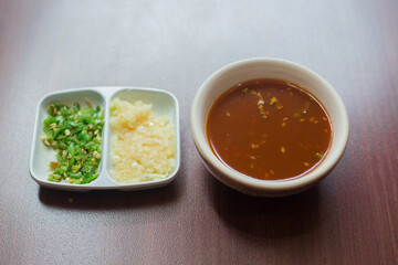 Suki sauce is a chili sauce suki asia style food jaew dipping sauce as thai spicy dipping sauce with chopped fresh chilli and minced garlic on the side