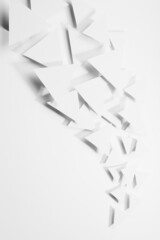 Abstract wave or white paper triangles flying in bright light with soft light shadows as flow, border, copy space, top view, vertical. Contemporary simple energy active airy abstract background.
