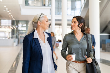 Businesswomen walking in corporate building