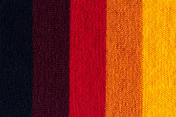 Fototapeta premium multi colored background. knitted wool fabric texture with stripes