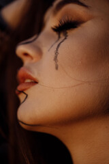 Emotional Hispanic girl crying in front of the camera. Charming female model