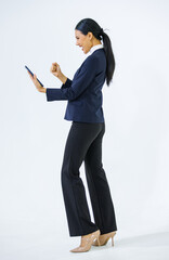 Studio shot Asian young beautiful female professional successful businesswoman model in formal business suit and turtleneck shirt standing holding smartphone taking selfie photo on white background