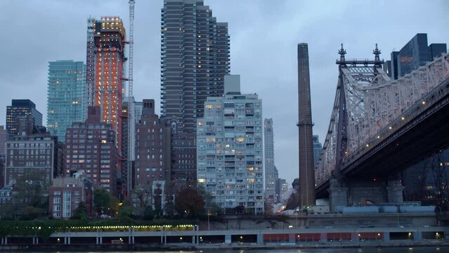 Evening view of NYC from Roosevelt Island. Queensboro bridge and traffic on FDR