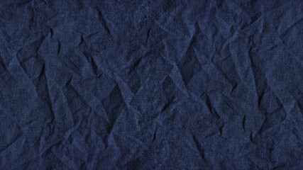 Blue crumpled fabric. Dark wrinkled fabric. Background with copy space for design.