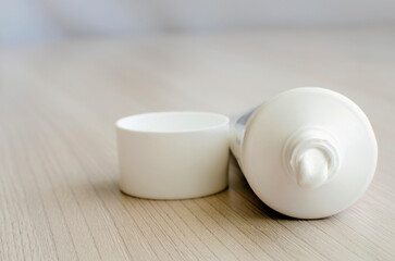 Open tube of cream. Close-up, selective focus.