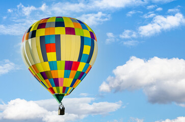 Colorful hot air balloon flying over blue sky