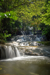 Beautiful long-exposure scenery of Wang Kan Lueang Waterfall in Lopburi province, Thailand.