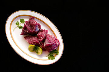 Fresh Beef Steaks decorated with vegetables and herbs on a white plate,Selective focus.