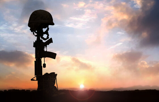 Fallen Soldier background concept with military helmet boots and rifle