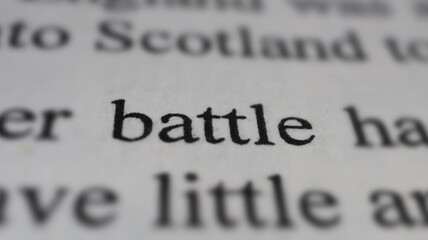 Battle text in open book page, close up, macro shot of church word, education and novel concept, selective focus