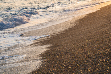 waves at sunset on the beach of Varigotti in Liguria, Italy