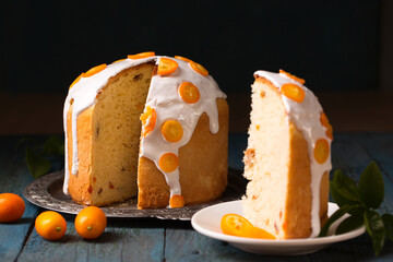 Easter cake and kumquats on a gray wooden background