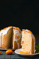 Easter cake and juicy kumquats on a gray background