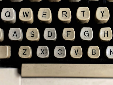 Old typewriter keyboard in vintage background. Stock photo.