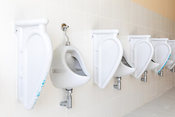 Row of urinal toilet blocks in men public toilet under construction