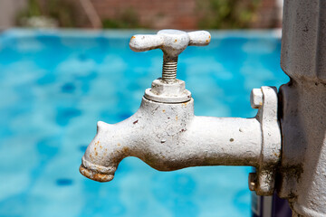 close-up of retro faucet with rust and cracked paint