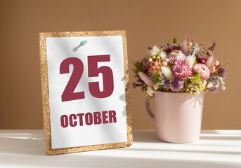 october 25. 25th day of month, calendar date.Bouquet of dead wood in pink mug on desktop.Cork board with calendar sheet on white-beige background. Concept of day of year, time planner, autumn month