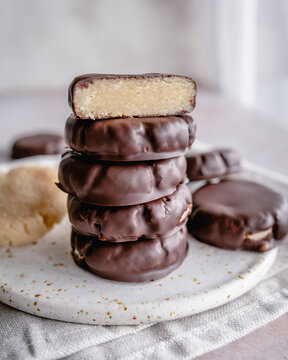 Stack of homemade healthy marzipan confectionery covered in dark chocolate