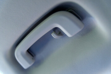 Overhead grab handle in car, showing handle and coat hook