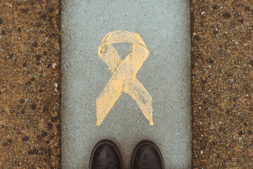 Overhead view of a person standing by a yellow ribbon symbolising pro-independence movement, Catalonia, Spain