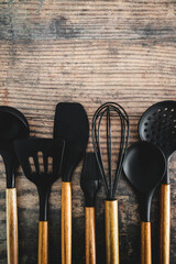 set of matching wooden and silicone kitchen utensils, cooking meals at home or learning to cook