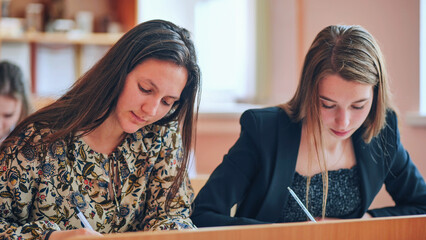 Pupils of the 11th grade in the class at the desks during the lesson. Russian school.