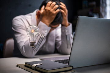 The flickering lights symbolize creative abilities reduced by the stress of hard work.