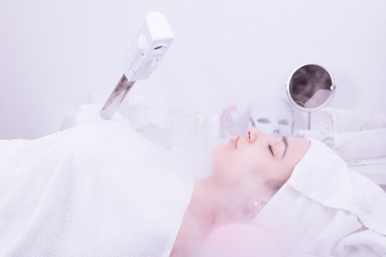 Beauty treatment of face with ozone facial steamer in beauty center. . High quality photo