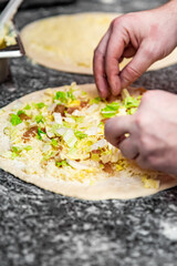 hand of chef baker making pizza at kitchen. The process of making pizza. cooking italian pizza