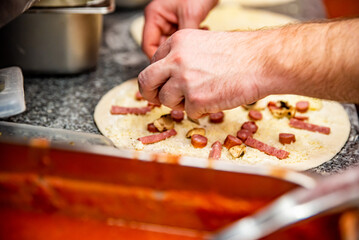 hand of chef baker making pizza at kitchen. The process of making pizza. cooking italian pizza