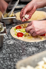 hand of chef baker making pizza at kitchen. The process of making pizza. cooking italian pizza