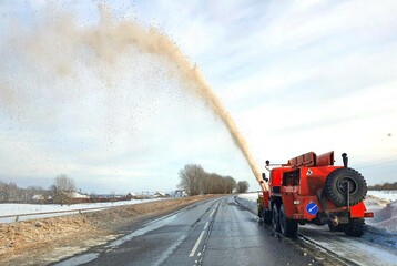 Snow removal equipment at work. A huge snowplow, sprays a snow avalanche with a long jet. Unusual...