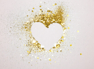 Heart with gold glitter stars on gray background. Can be used as place for your text, design element