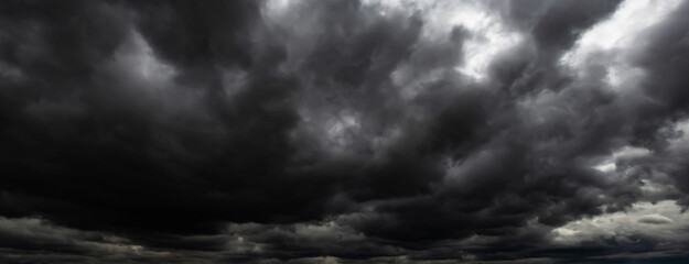 black clouds. Before a heavy rainstorm, the sky was covered with clouds with lightning and strong...