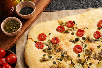 Floral painting focaccia, italian garden flatbread art with parsley, tomatoes, onions, sesame seeds...