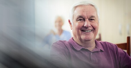 Blur effect with copy space against caucasian senior man smiling at retirement home