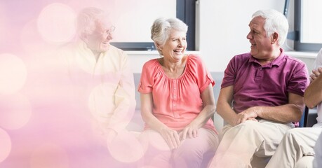 Blur effect with copy space against group of senior people laughing together at retirement home