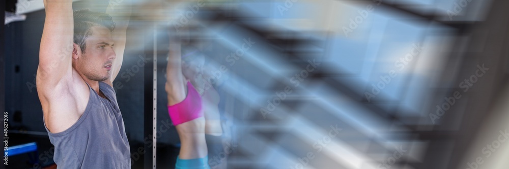 Poster blur effect with copy space against caucasian fit man performing pull up exercise at the gym