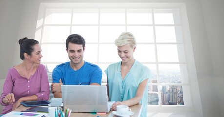 Composite image of group of people using laptop against view of cityscape from office window